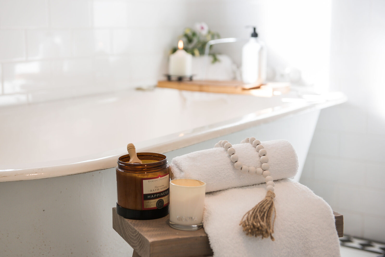 Freestanding bath styled with candles and towels