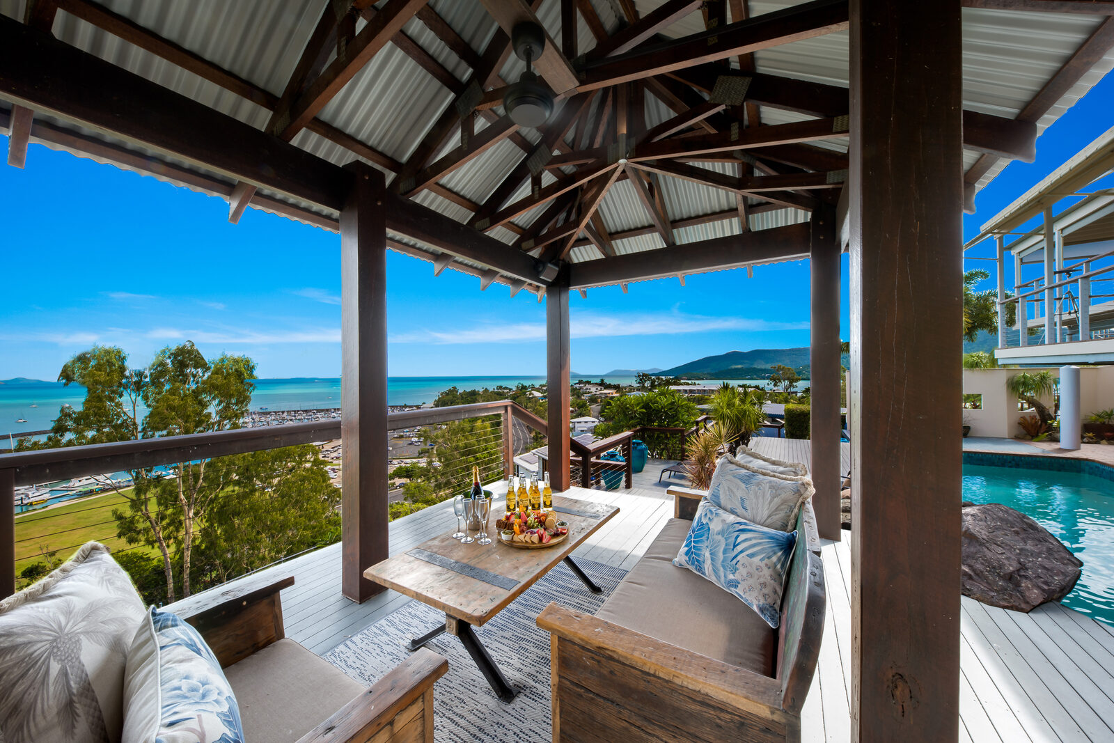 Poolside cabana set for drinks with island views