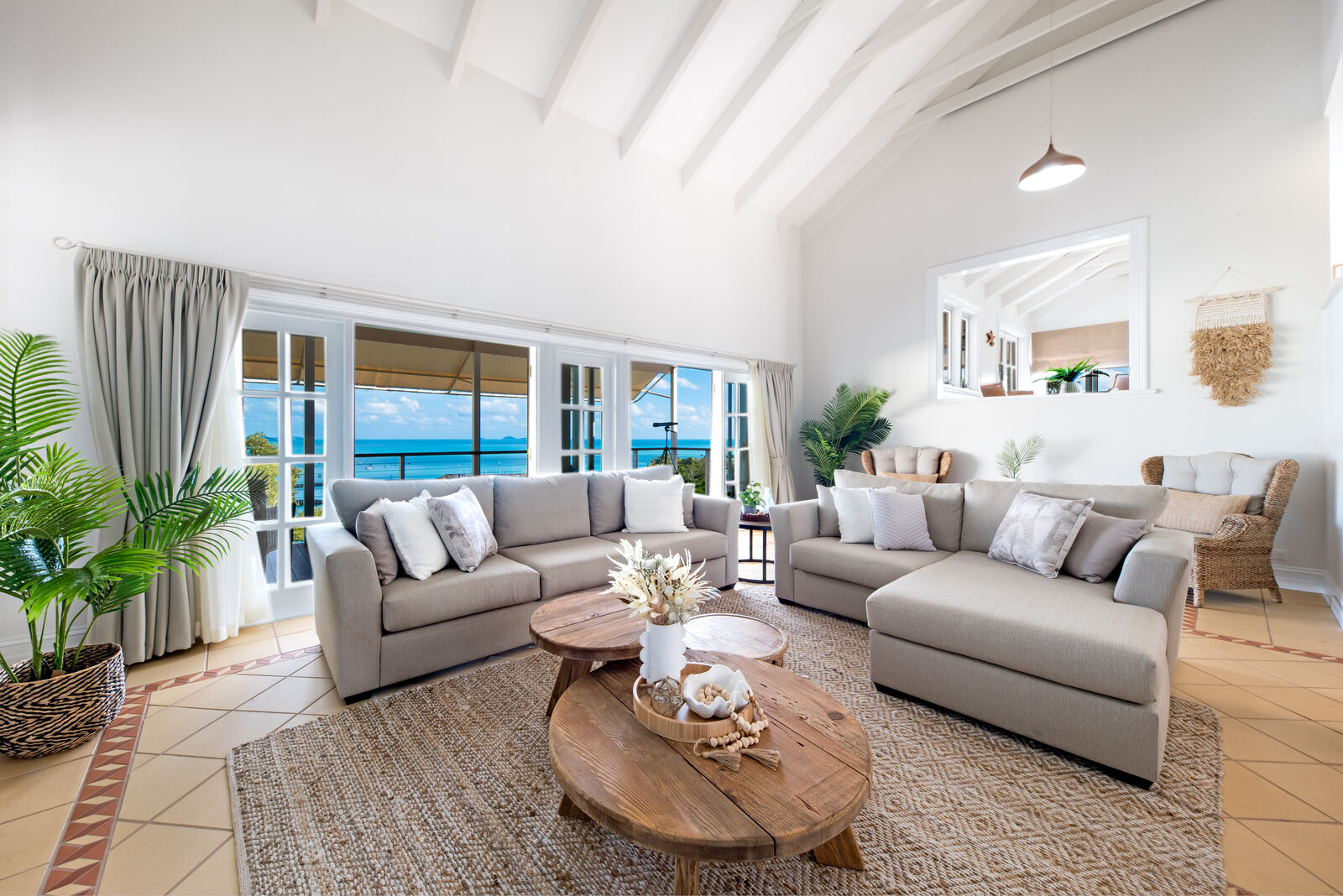Bright coastal living room with sea views and vaulted ceiling