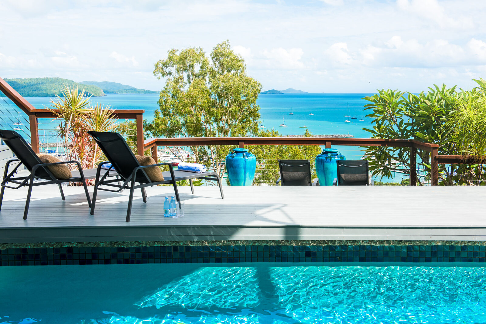 Infinity-edge pool and poolside cabana overlooking Coral Sea Marina